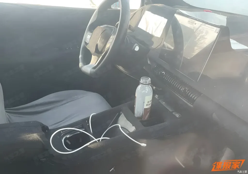 BYD Dolphin G DM-i interior spy photo displaying minimalist floating central touchscreen.