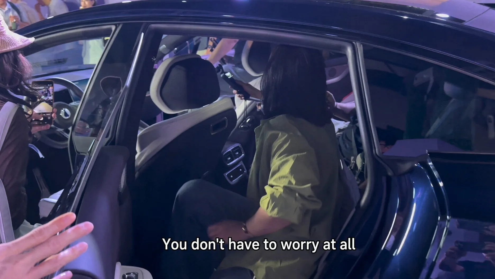 A guest getting into the rear seat of the Denza Z9S at the launch event