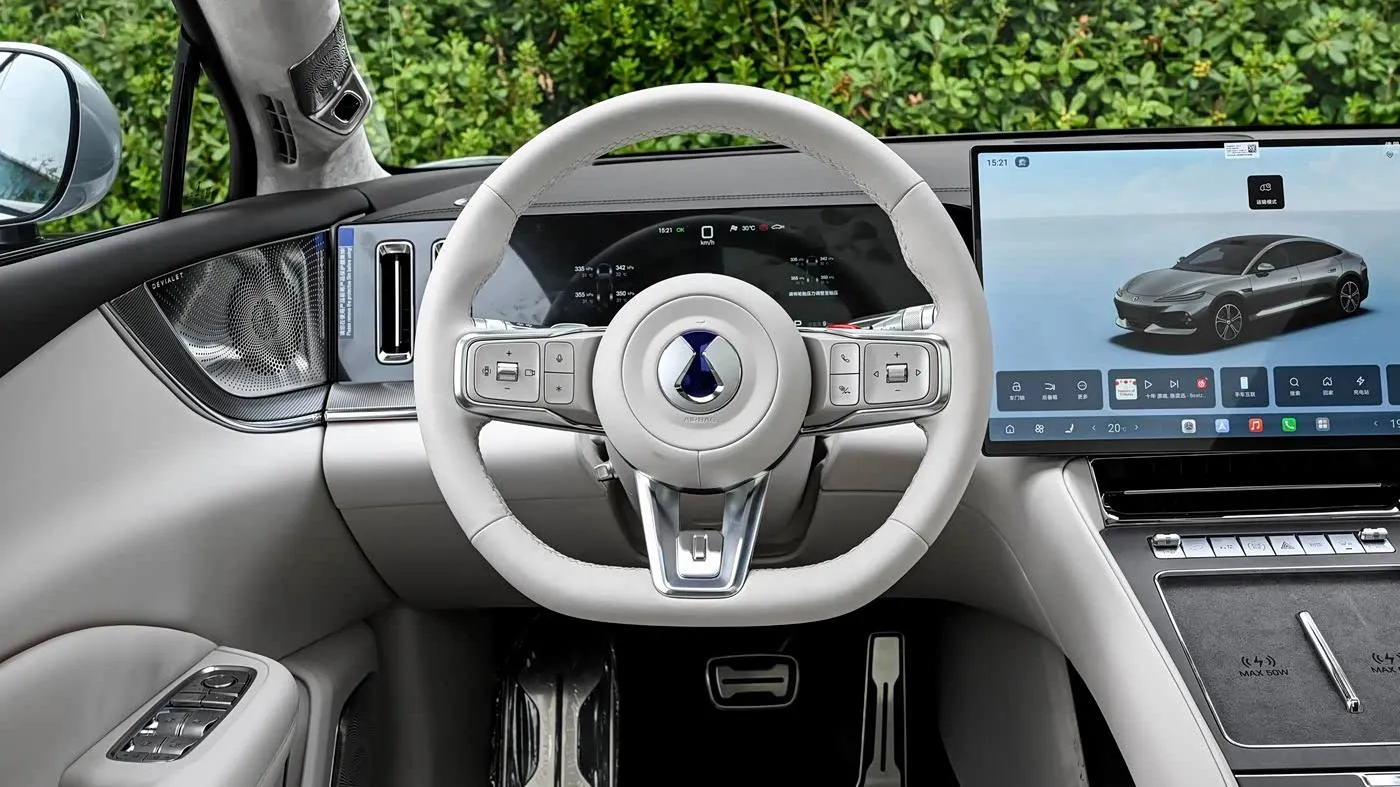 Denza Z9S driver area with steering wheel, instrument display and Devialet speaker grille